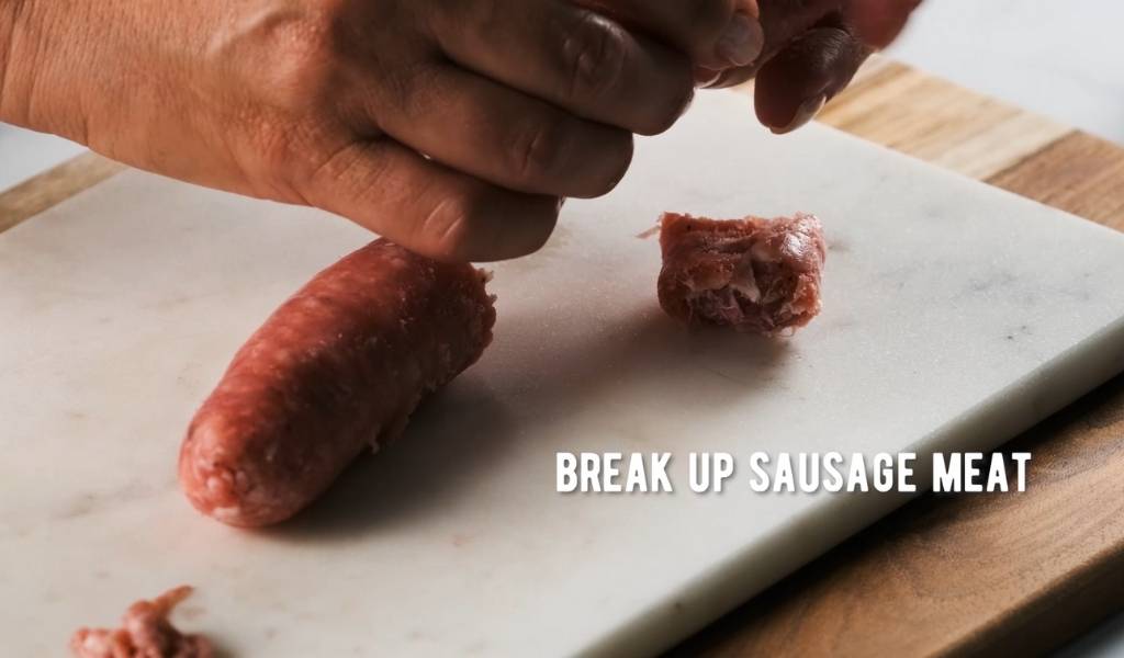 Step 3 to removing sausage casings - break up meat