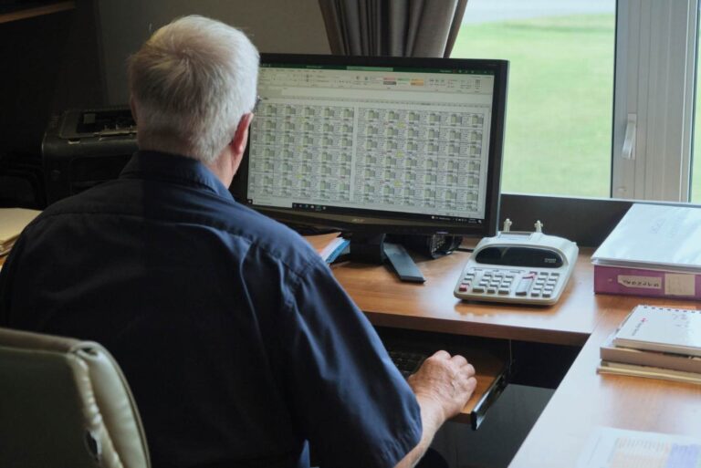 Ontario pork producer sitting in front of a computer